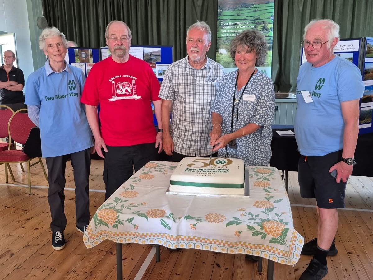 Sue Viccars cutting the Two Moors Way 50th anniversary cake